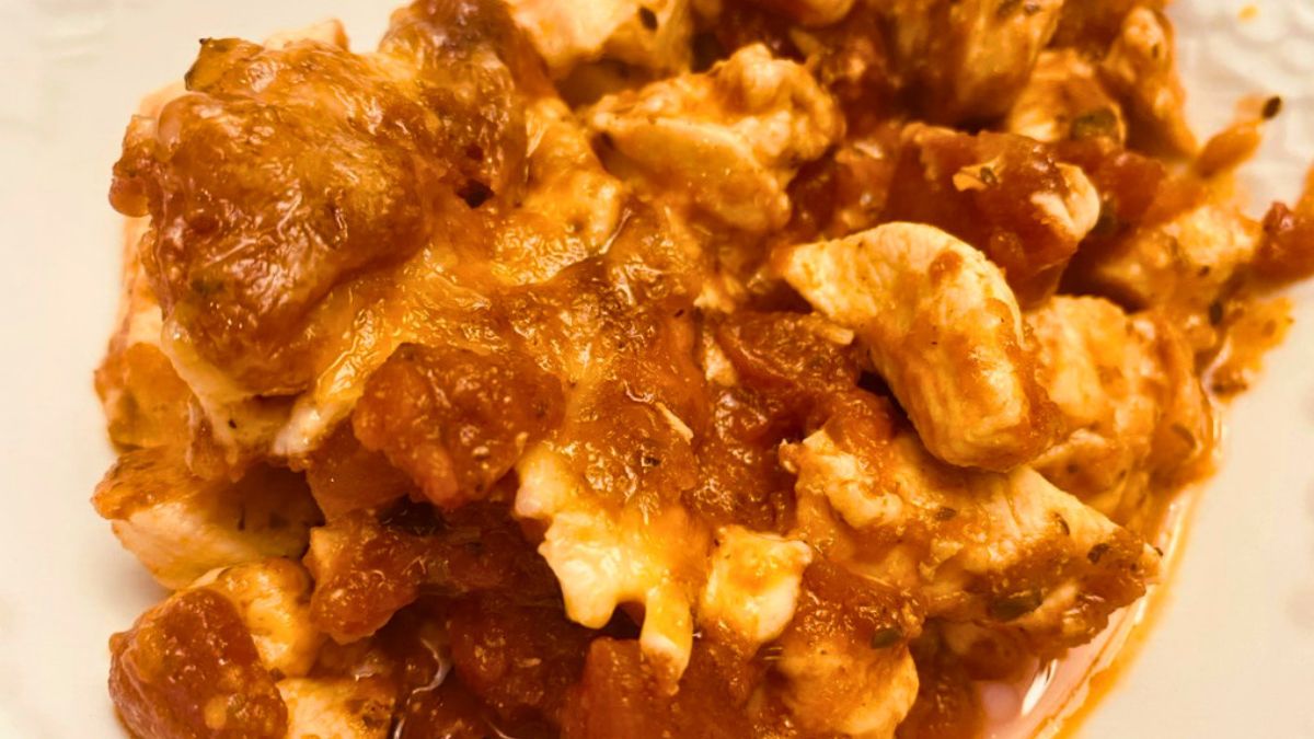 Close-up of crustless garlic chicken pizza with melted cheese and tomato sauce