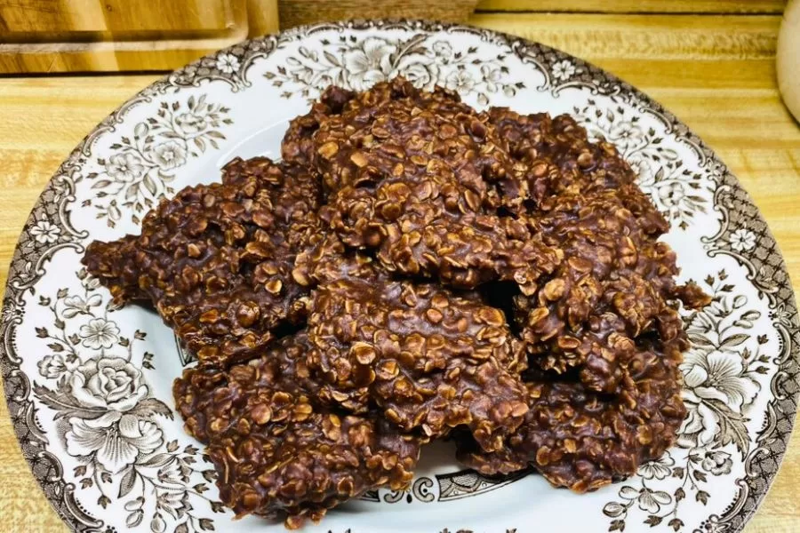 No-bake chocolate oatmeal cookies stacked on a vintage floral plate