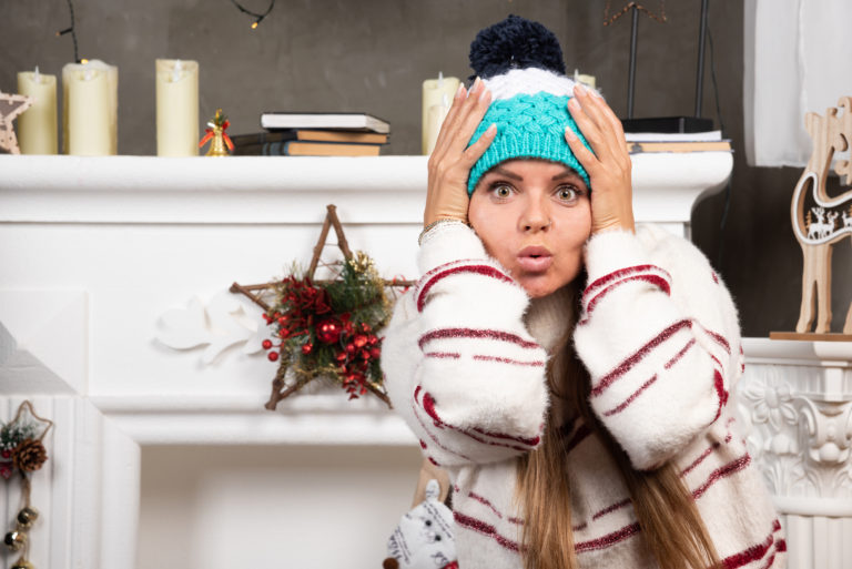 Portrait of young woman holding her head because of surprise