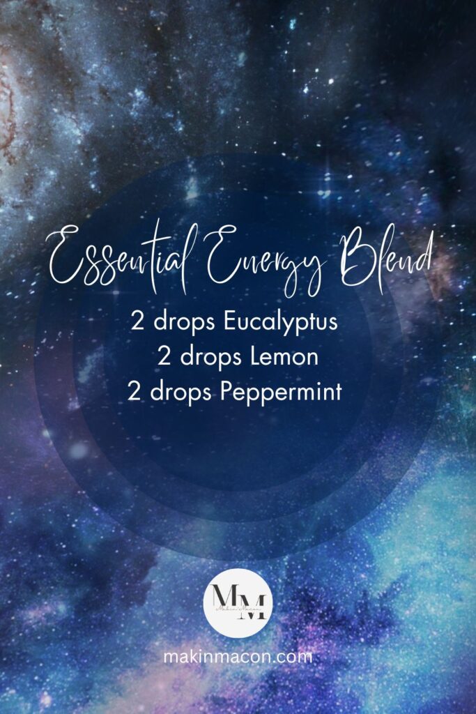 Essential Energy Blend Pinterest pin with a galaxy background and text overlay listing 2 drops each of eucalyptus, lemon, and peppermint essential oils.