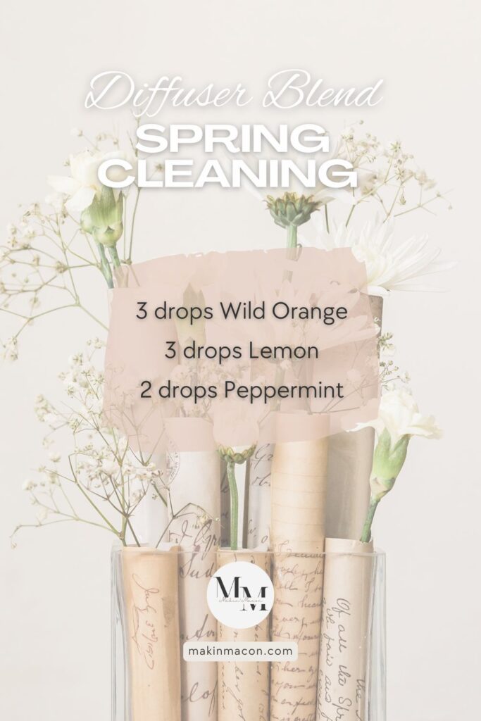 Spring Cleaning diffuser blend with wild orange, lemon, and peppermint essential oils on a soft floral background