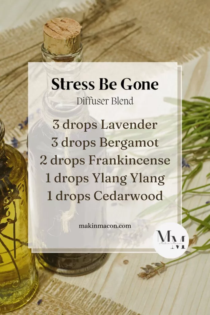 Stress Be-Gone diffuser blend pin with recipe: 3 drops lavender, 3 drops bergamot, 2 drops frankincense, 1 drop ylang ylang, 1 drop cedarwood on a rustic background with oil bottles and lavender.