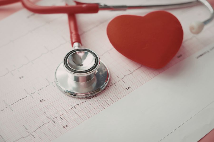 Stethoscope and heart symbol on medical chart representing prayer as the heartbeat of the soul