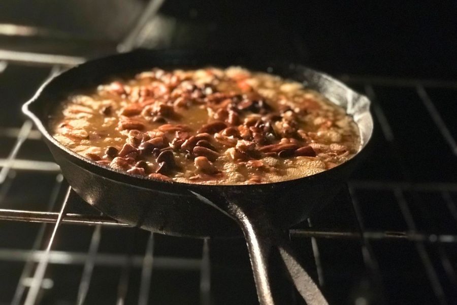 Keto caramel pecan bars baking in a cast iron skillet, low carb dessert