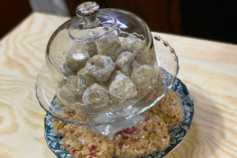 Keto pecan snowball cookies dusted with powdered sweetener on a serving tray