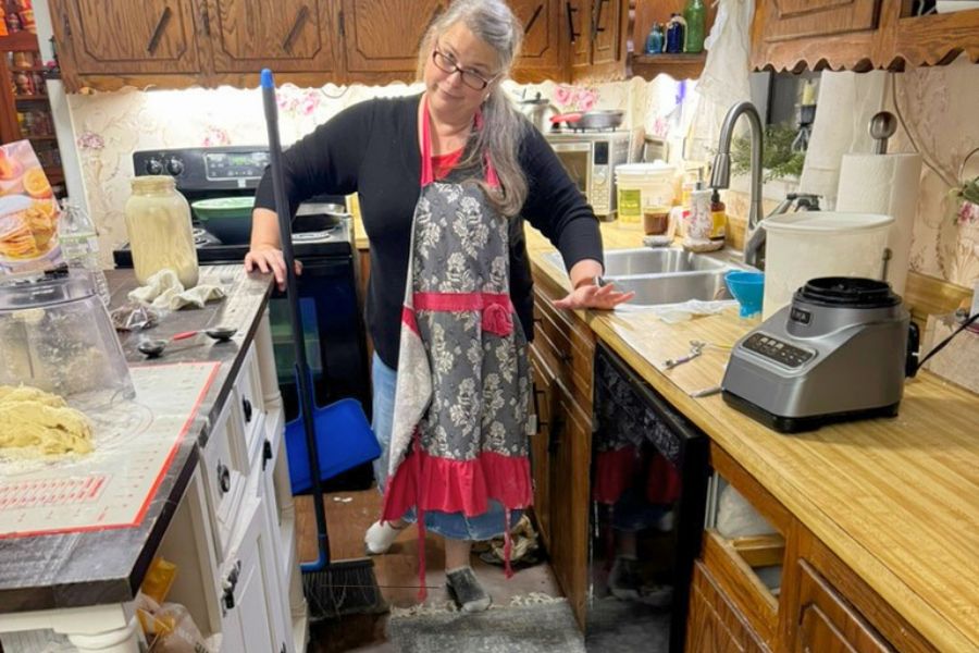 Mom cleaning a busy kitchen while baking, showing real life and thriving through everyday chaos