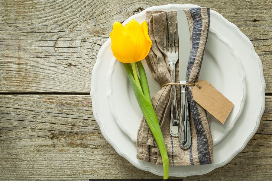 Easy family meals for spring with comforting, frugal recipes perfect for busy homemakers and Sunday dinners. Blog banner featuring a spring table setting with yellow tulip.