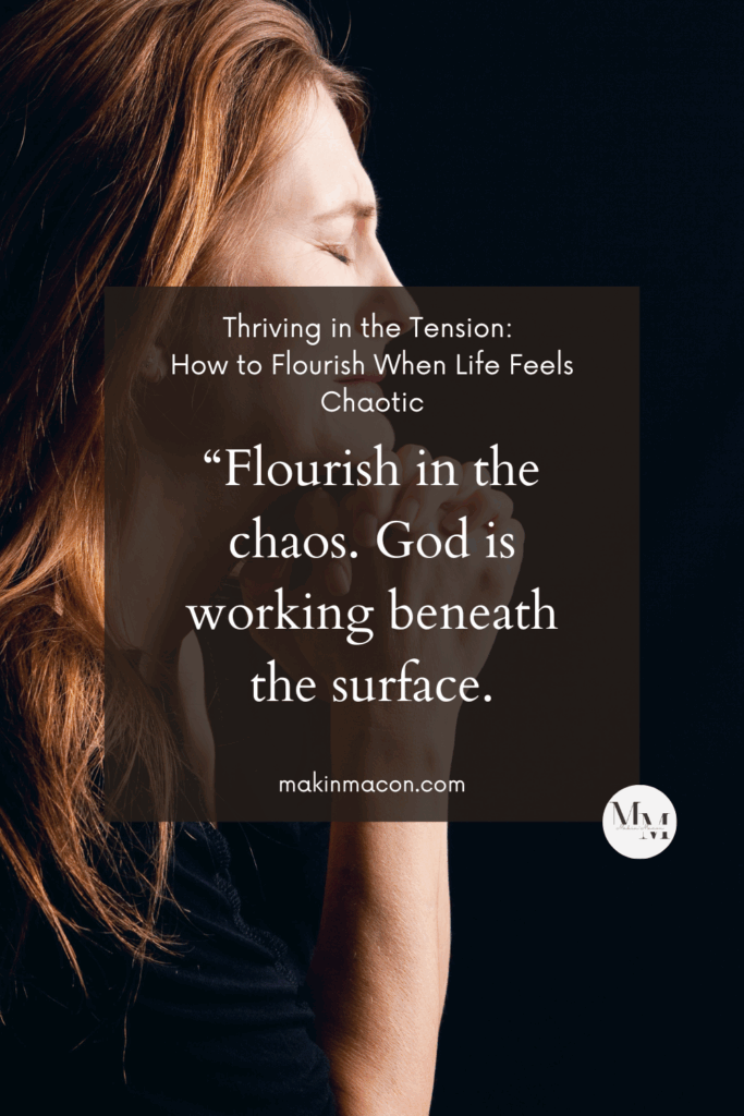 Woman praying with eyes closed, hands folded near her face; overlay text reads “Flourish in the chaos. God is working beneath the surface.”