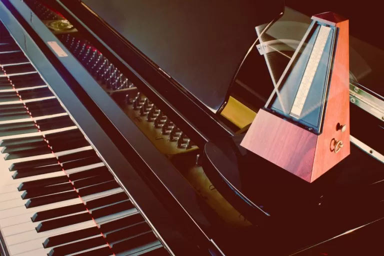Metronome on piano keys symbolizing finding your rhythm in life and faith