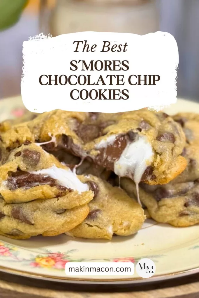 Close-up of gooey s’mores chocolate chip cookies with melted marshmallow and chocolate on a floral plate. Text overlay reads “The Best S’mores Chocolate Chip Cookies” with the makinmacon.com logo.