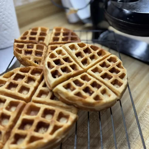 • Fresh milled flour is thirstier than store-bought flour, which is why the rest time is important. • Soft white wheat keeps these waffles mild in flavor and kid-friendly. • These waffles freeze well. Let them cool completely, then lay them flat to freeze before transferring to a zip-top freezer bag. • Waffles can be reheated in a toaster or toaster oven for quick breakfasts. • If the batter thickens too much after resting, stir in a small splash of milk before cooking.