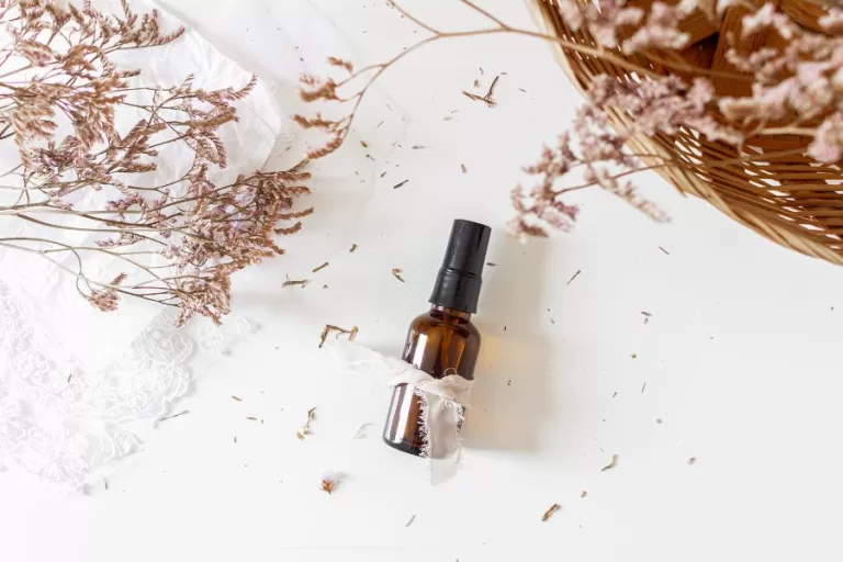 Loved and Known essential oil room spray in an amber bottle styled for a February blend with soft florals