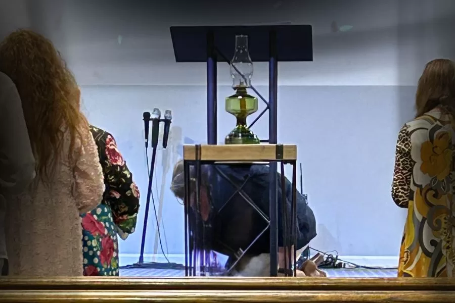 Intercessory prayer at the altar during church service, pastor’s wife kneeling in spiritual warfare.