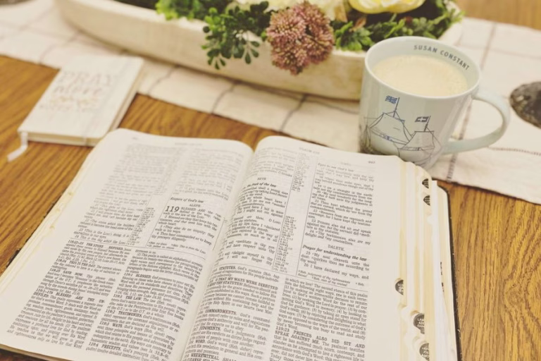 Open Bible with coffee on wooden table representing guarding your heart in a noisy world and quiet time with God