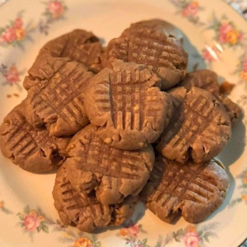 Keto peanut butter cookies on a floral plate, soft and chewy homemade low carb dessert