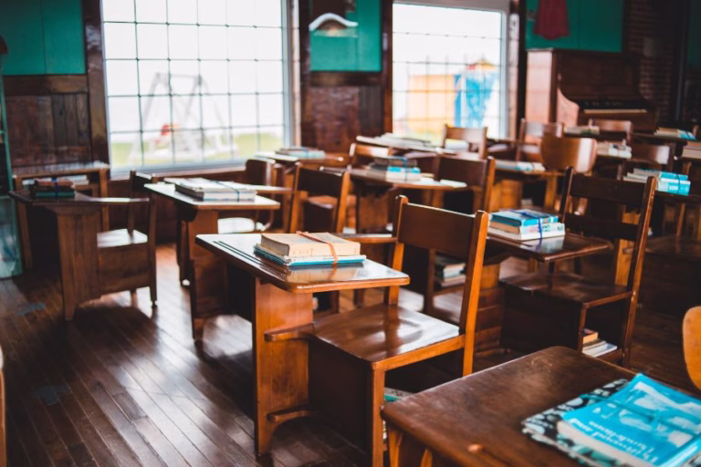 Vintage classroom with wooden desks and books, representing a back-to-school essential oil blend for focus and learning inspired by James 1:5.
