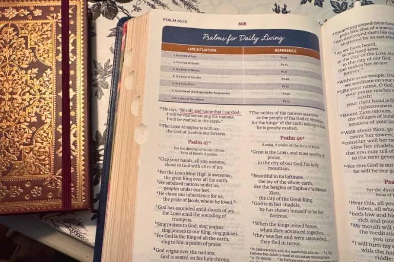 Open Bible turned to Psalm 46 with “Be still, and know that I am God” highlighted, representing how to keep God first in a busy season.